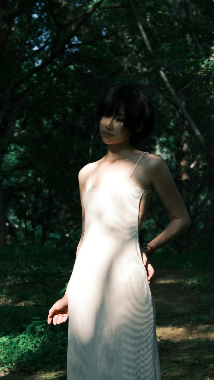 Ni-yoki framed by vibrant botanical leaves and soft natural sunlight