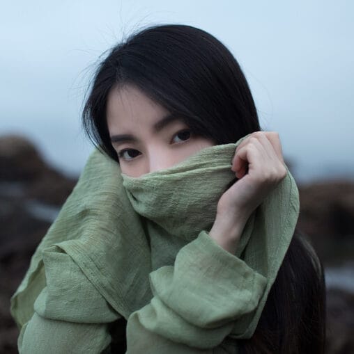 Fine art portrait of a woman veiled in sage green fabric by Anshen Lv