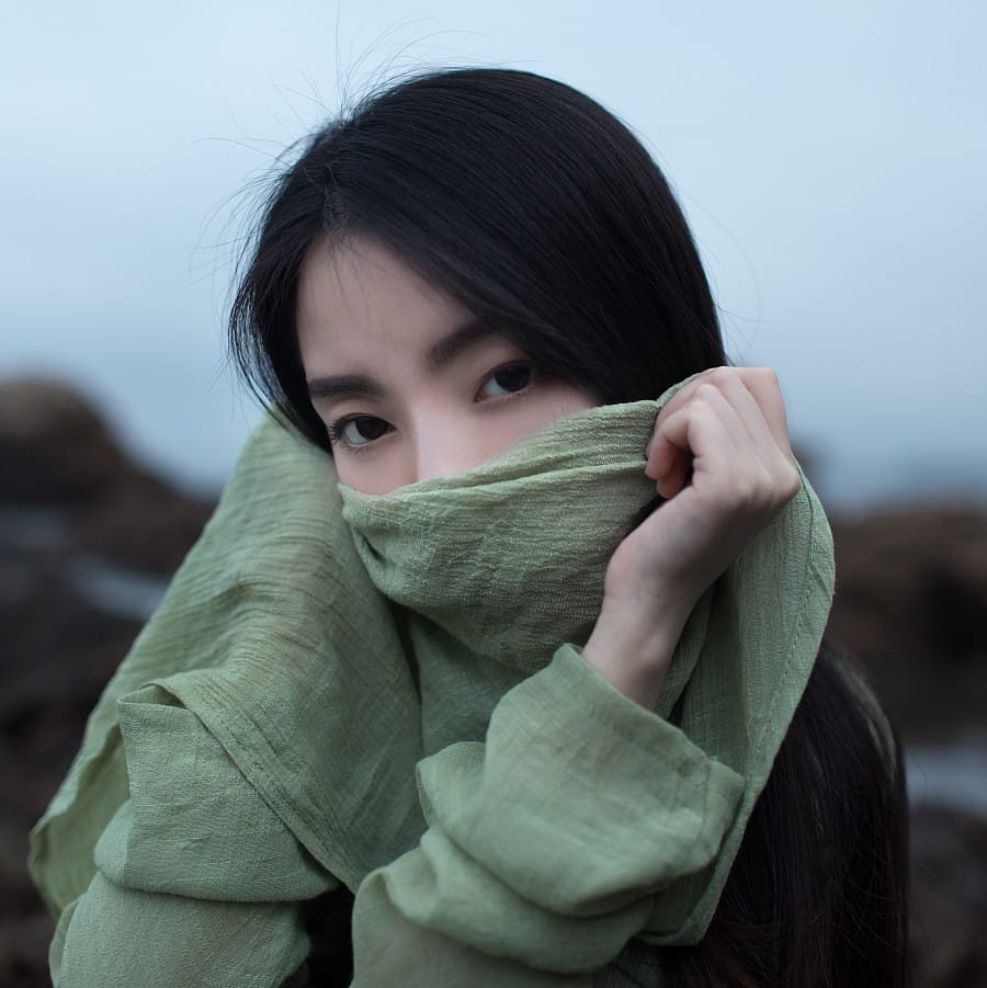 Fine art portrait of a woman veiled in sage green fabric by Anshen Lv